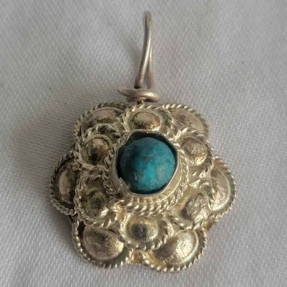 Detailed sterling silver boho pendant with natural turquoise stone